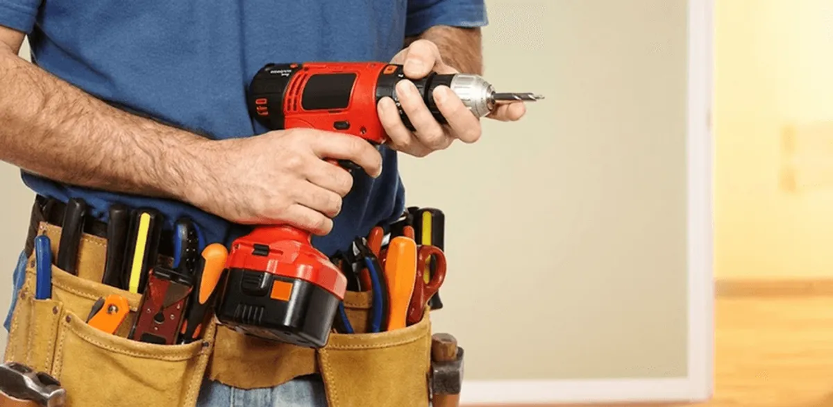 Handyman holding a power drill for home repairs and installations in Allentown, PA